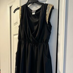 Little black dress with gold sequin around the arm area brand new never worn
